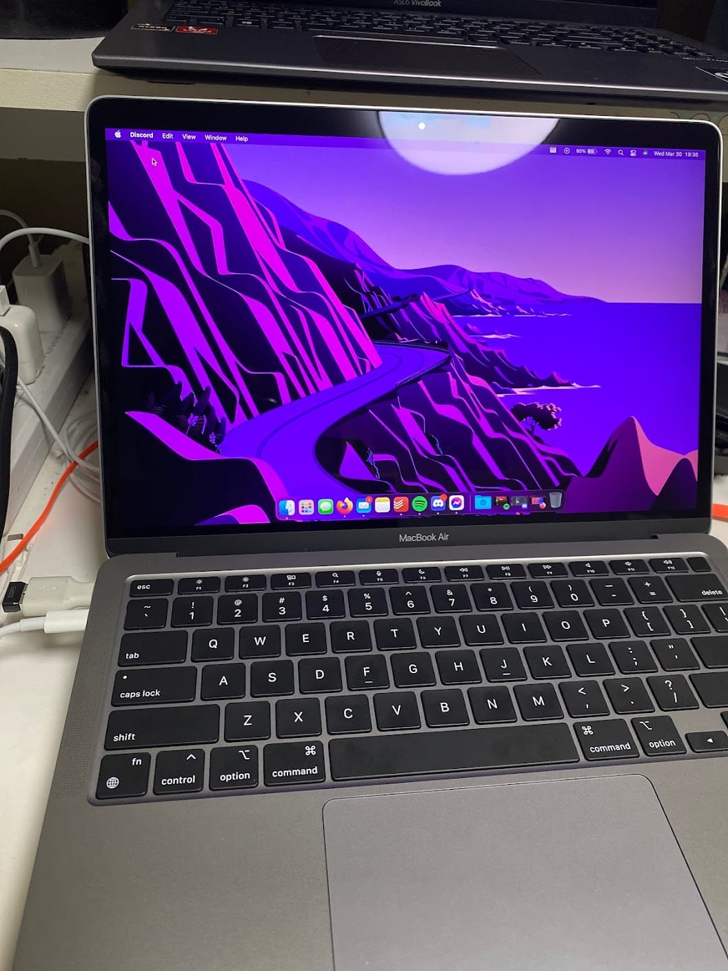 My new MacBook on the desktop with some apps in the dock opened